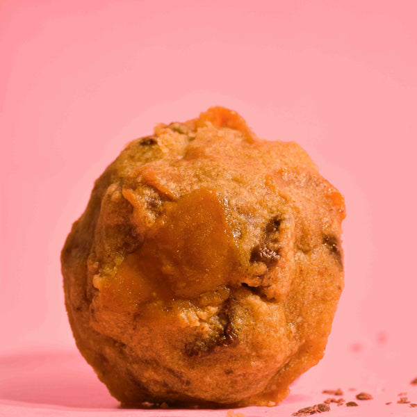 New York style cookie NYC cookie, with butterscotch toffee , sea salt topping with soft gooey center on a pink background photography.