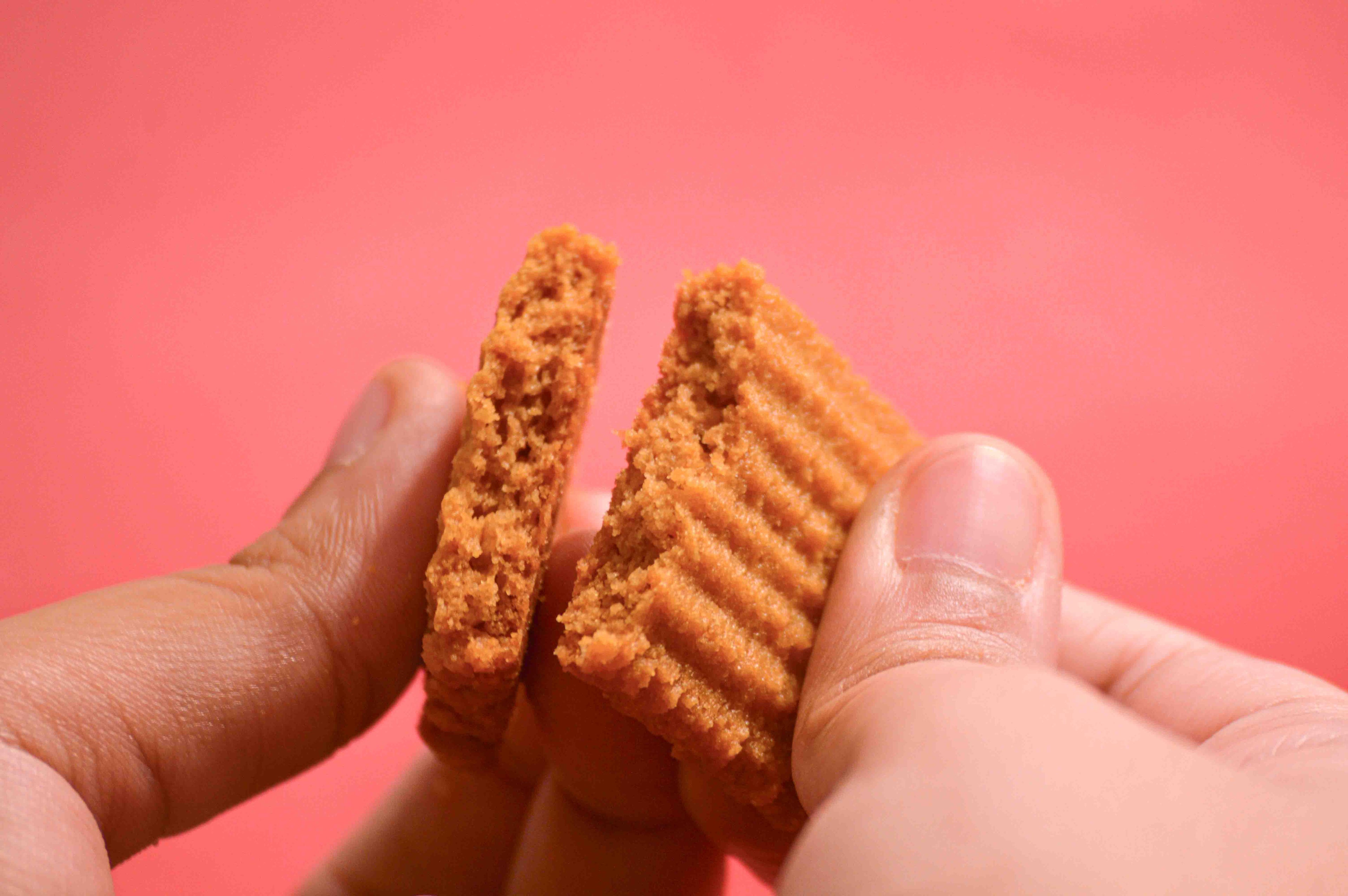 Biscuit Breaking in half against a pink background