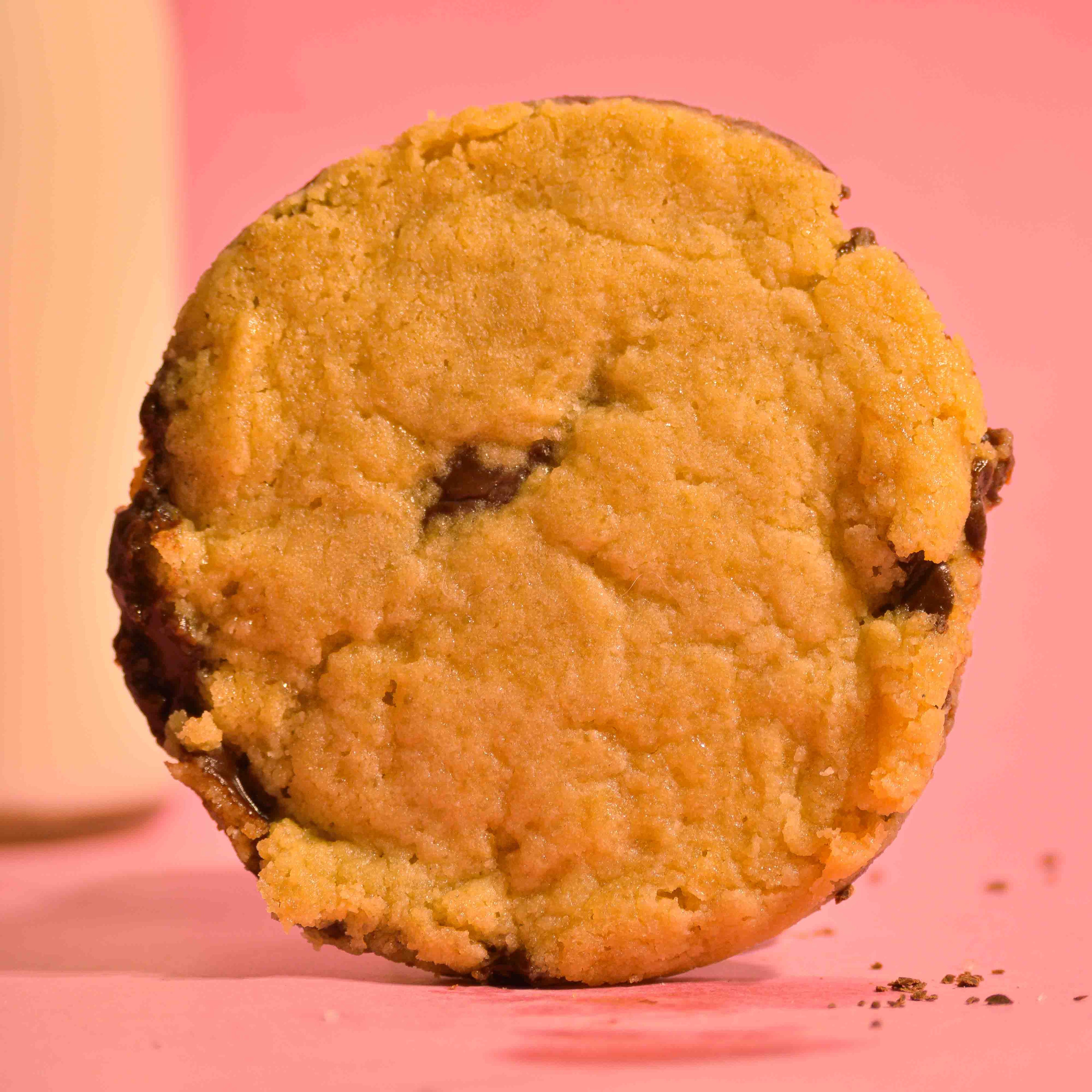 Petite Pleasure center filled Nutella lava cookie, sea salt topping with soft gooey center on a pink background photography.