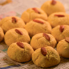 Indian Nankhatai on hindi newspaper with almonds as the topping photography inspiration