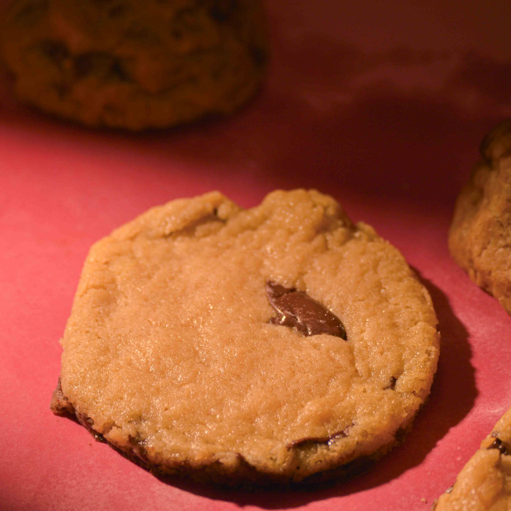 Thick Nutella lava center filled cookies topped with sea salt gooey center and crispy edges on a pink background professional photography